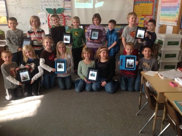 First Graders involved in an iPad Writing Project pose in Sabetha Elementary School with their iPads.